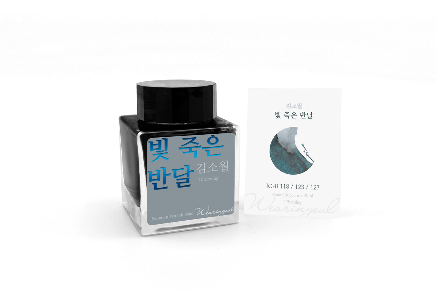 Ink bottle with its packaging on a white background