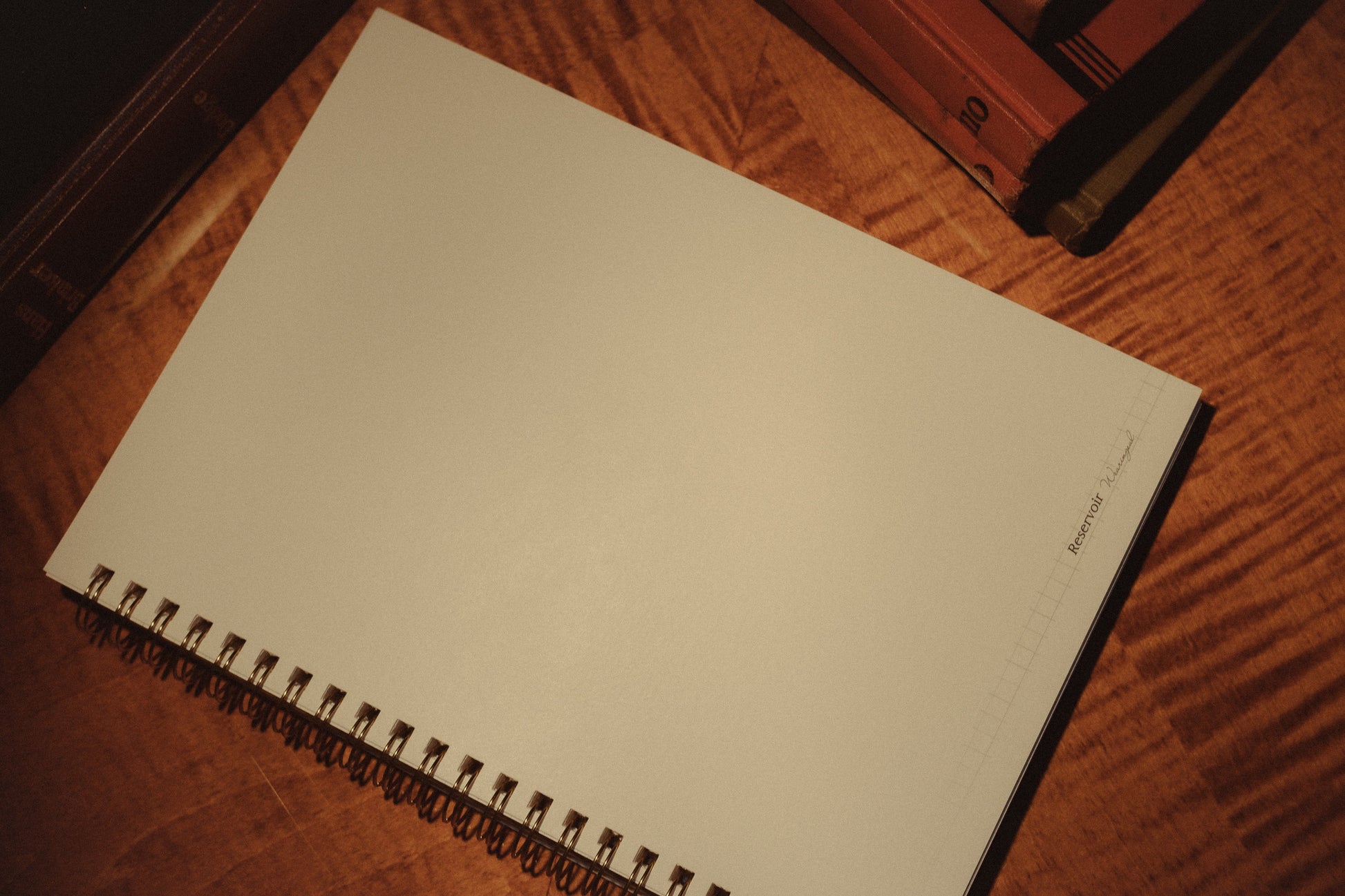Blank spiral-bound notebook on a wooden surface